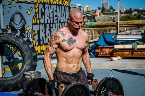 Does working out increase testosterone, a man training with heavy weights