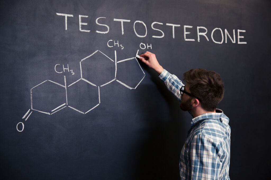Man writing testosterone's chemical formula on a chalk board