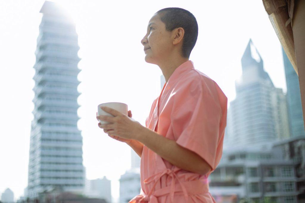 Testosterone and Chemotherapy for Breast Cancer [Guide], a woman with very short hair in pink clothes